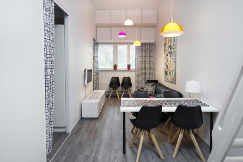 a kitchen and dining room with a table and chairs at Innotelli Apartments in Helsinki