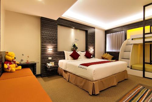 Postel nebo postele na pokoji v ubytování Bossotel Bangkok