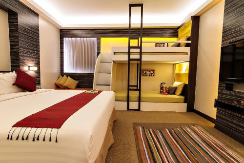 a bedroom with a bed and a bunk bed at Bossotel Bangkok in Bangkok