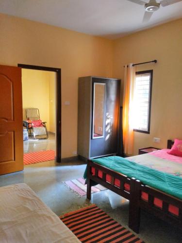 Postel nebo postele na pokoji v ubytování Cordel Farms Mangalore