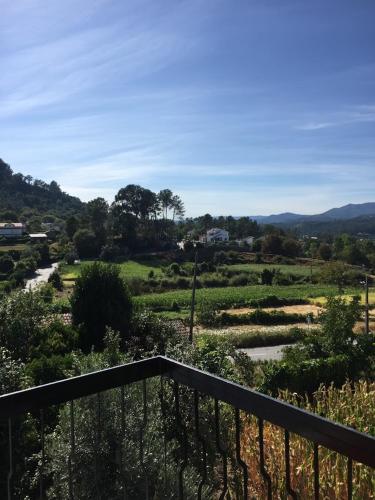 a balcony with a view of a green field at DDS-Dominio das Sem&ntes in Vouzela