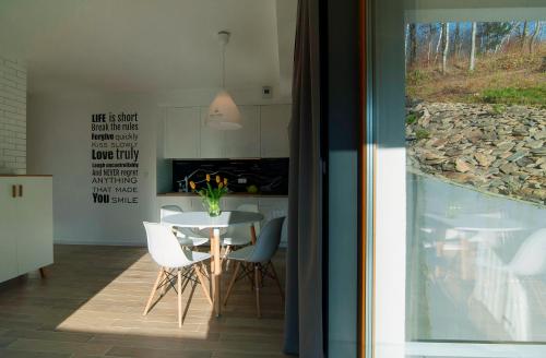 a kitchen and dining room with a table and chairs at Apartamenty Willowa in Szczyrk