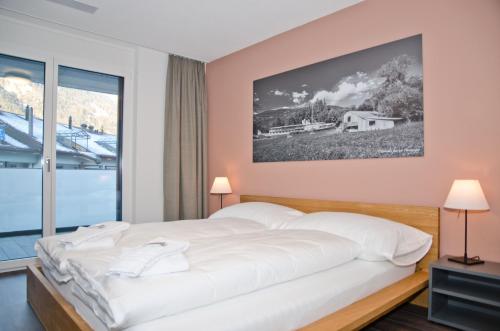 Ένα ή περισσότερα κρεβάτια σε δωμάτιο στο Apartment Narzisse - GRIWA RENT AG