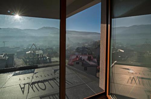 a view of a city from a window at Apartamenty Willowa in Szczyrk