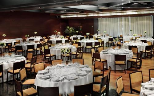 a banquet hall with white tables and chairs at Hotel Nelva in Murcia
