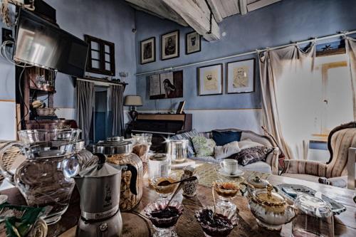 a living room with a table with dishes on it at Viandanti, Artisti e Sognatori in Comano