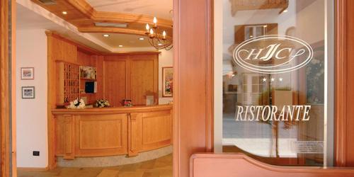 a reflection of a kitchen in a store window at Hotel Italia in Baselga di Pinè