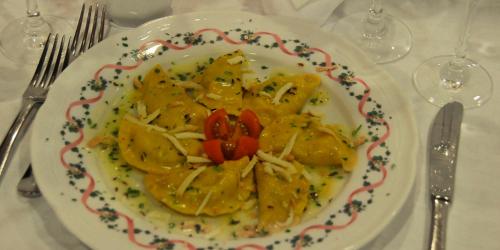 a plate of food with pasta on a table at Hotel Italia in Baselga di Pinè