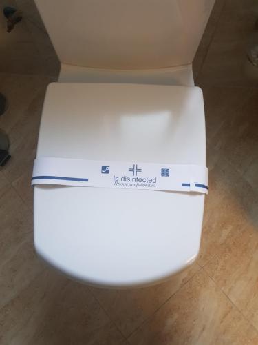 a white toilet with a box on the lid at Едем in Brzezhany