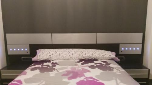 a bedroom with a bed with a large headboard at Apartamento el Benicadell in Adzaneta de Albaida
