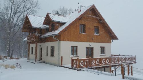 a large house with snow on the ground at Uroczysko starych sztolni in Szklarska Poręba