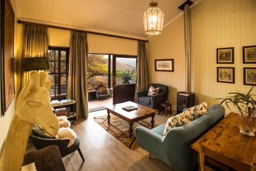 a living room with a couch and a table at Three Tree Hill Lodge in Bergville