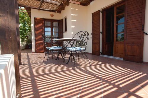 a patio with chairs and a table on a porch at Villa Filiza in Sívas