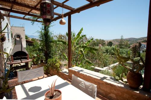 a patio with a table and chairs and a grill at Villa Filiza in Sívas