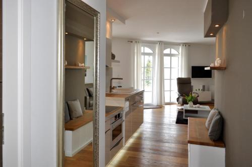 a kitchen with a sink and a mirror at Meereszeichen in Baabe