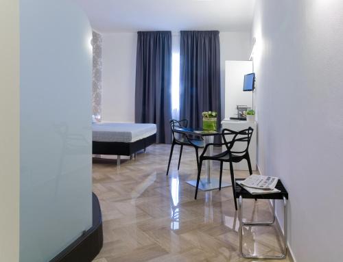 a room with a bed and a table and chairs at Viasparano B&B in Bari