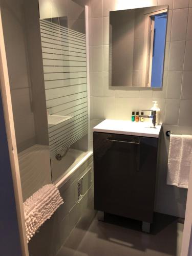 a bathroom with a shower and a sink and a mirror at The Site apartment in Pas de la Casa