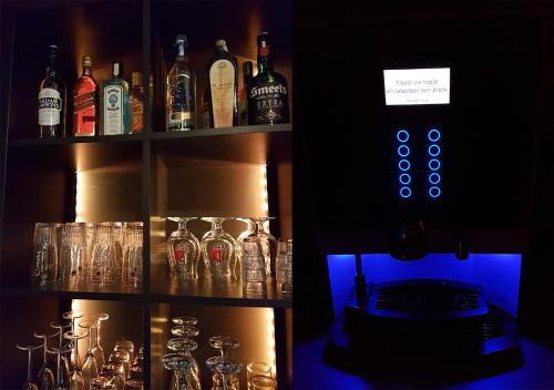 a shelf filled with glasses and bottles of alcohol at Hotel Goodnight Antwerp in Antwerp