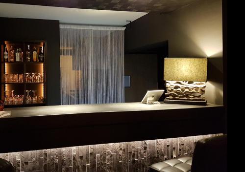 a bar with a desk with a laptop on it at Hotel Goodnight Antwerp in Antwerp