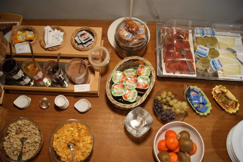 a wooden table topped with different types of food at Hôtel Central in Pau