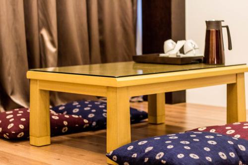 a wooden table with a glass top on a table with pillows at 日光微醺 in Luodong