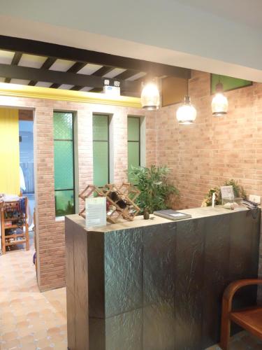 a kitchen with a counter in a room at Baan Baimai Boutique Room in Phra Nakhon Si Ayutthaya