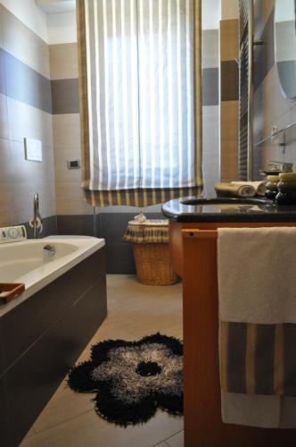 a bathroom with a sink and a bath tub at Sand 228 Home in Terracina