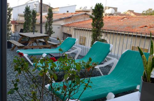 two chairs and a table on a patio at St. Lazaros Studios in Larnaka