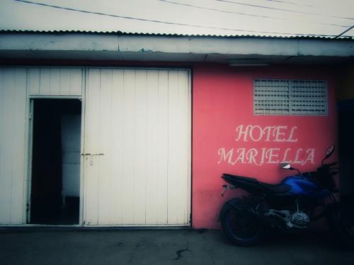 a motorcycle parked in front of a garage at Hostal Mariella in Estelí