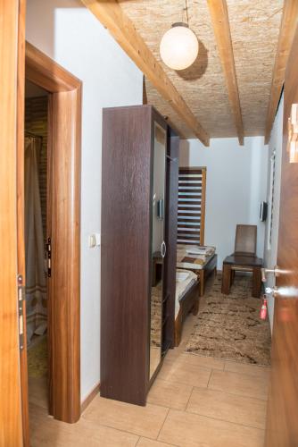 a hallway with a door and a room with a bench at Motel Orhideja in Donji Vakuf
