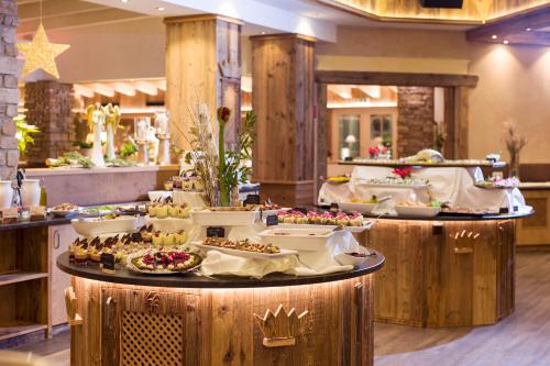a buffet line with appetizers and desserts on display at Hotel Panorama Royal in Bad Häring