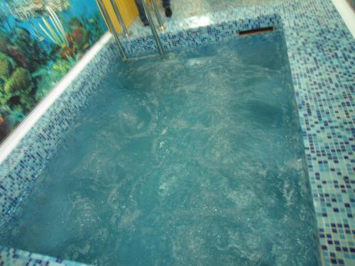 a swimming pool filled with water in a building at Hotel Vatra in Lviv