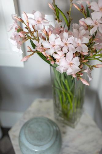a vase filled with pink flowers on a table at Villa Maria Boutique Hotel in Cannobio