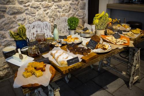 a table filled with lots of different types of food at Amymone Suites in Nafplio
