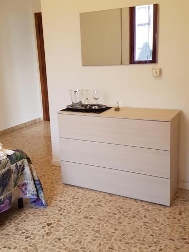 a dresser with a mirror on top of it at B&B Buscemi in Pistoia