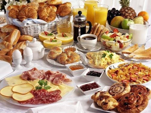 a table topped with lots of different types of food at Argo Apartments in Kato Daratso