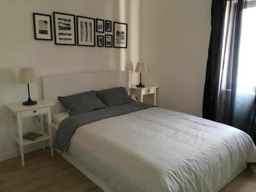a bedroom with a bed with two tables and two lamps at Casa da Fonte in Foz do Arelho