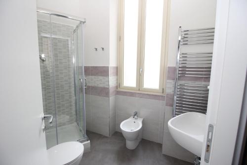 a bathroom with a toilet and a sink and a shower at Oasi del Turista in Palermo