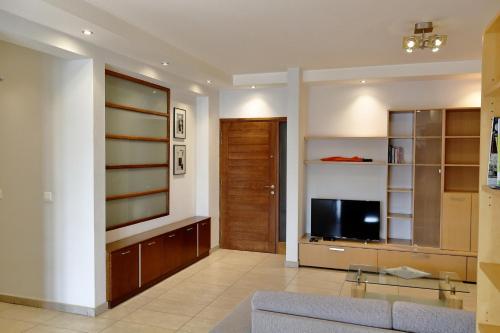 a living room with a couch and a tv at Kornesios Suite in Nicosia