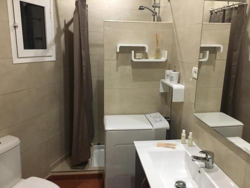 a small bathroom with a toilet and a sink at Rosamar in Los Cristianos