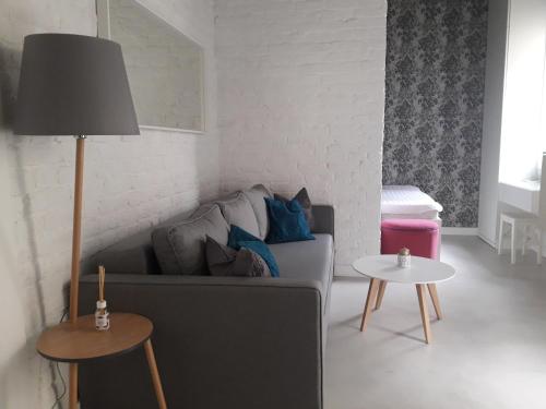 a living room with a couch and a table at Momo Apartment in Belgrade