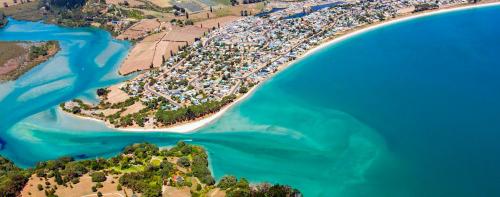 an aerial view of a beach and the water at Admiral Waters in Cooks Beach