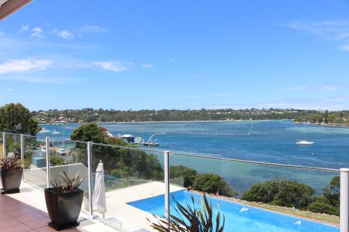 a balcony with a view of a body of water at Sybella in Merimbula