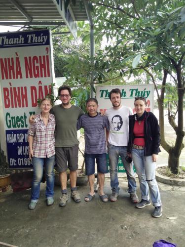 a group of people standing in front of signs at Thanh Thúy Guesthouse in Ðông Hà