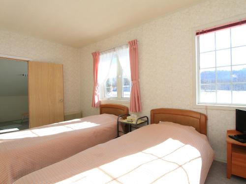 เตียงในห้องที่ Pension Himawari