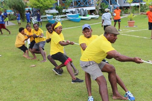 a group of children playing a game of baseball at Rapopo Plantation Resort in Kokopo