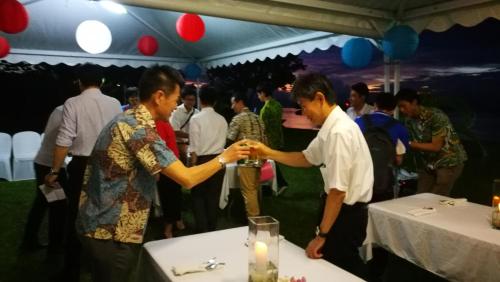 a man and a woman shaking hands at a party at Rapopo Plantation Resort in Kokopo