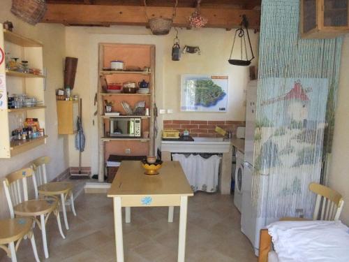 a kitchen and dining room with a table and chairs at Gite La Paillote in Montauroux
