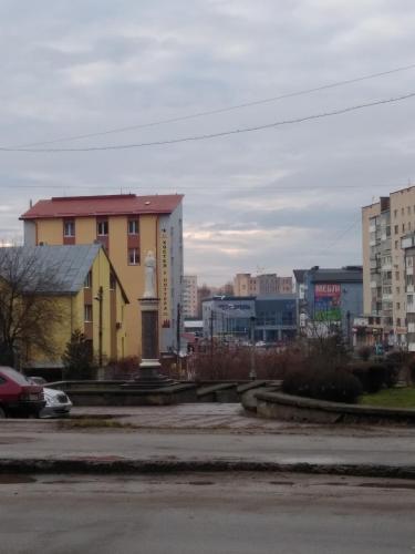 a parking lot in a city with buildings at У Поттера in Ternopilʼ