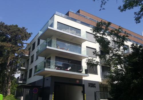 a white building with balconies on the side of it at Forest Park by Zoom Apartments in Bratislava